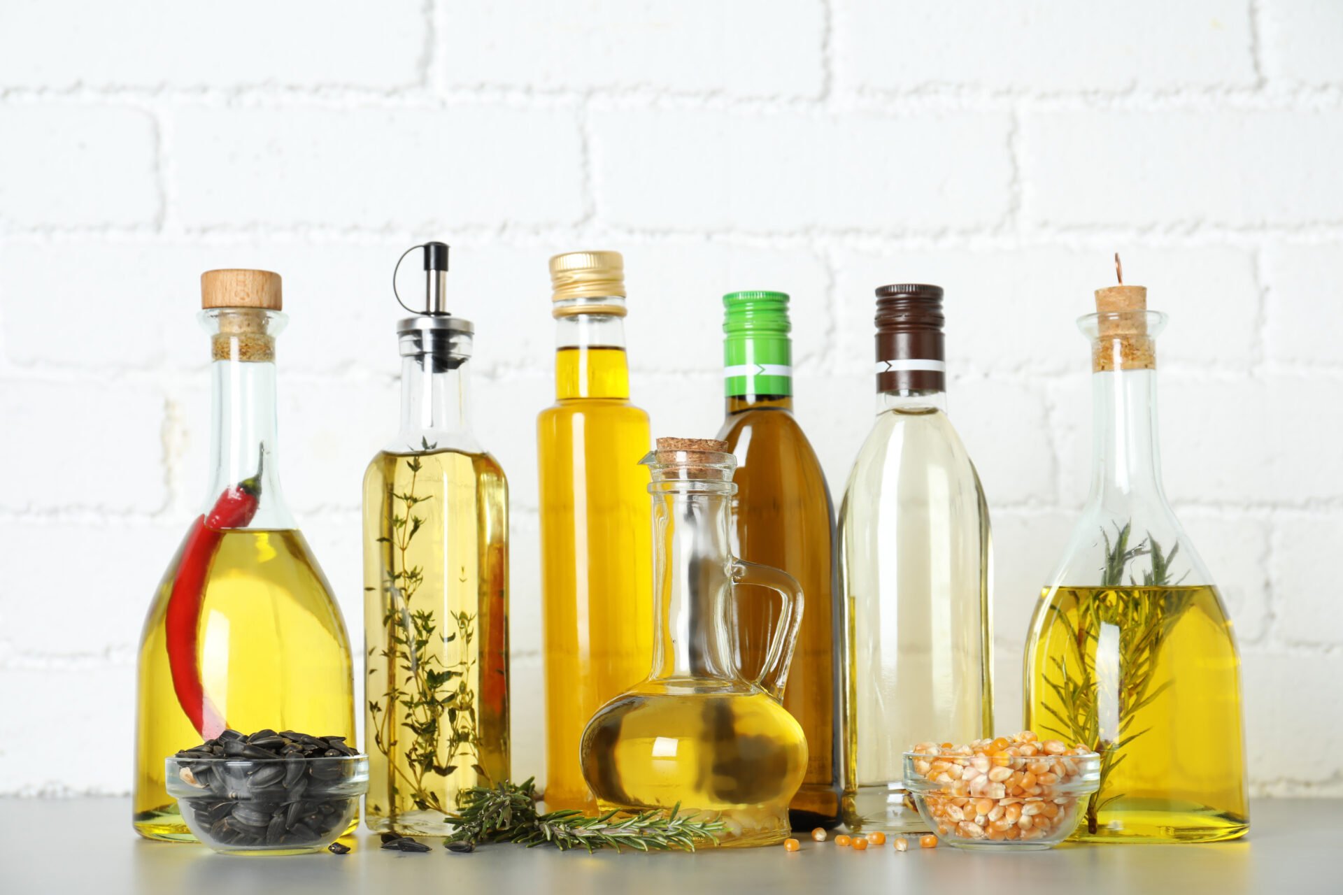 Different cooking oils in bottles on grey table