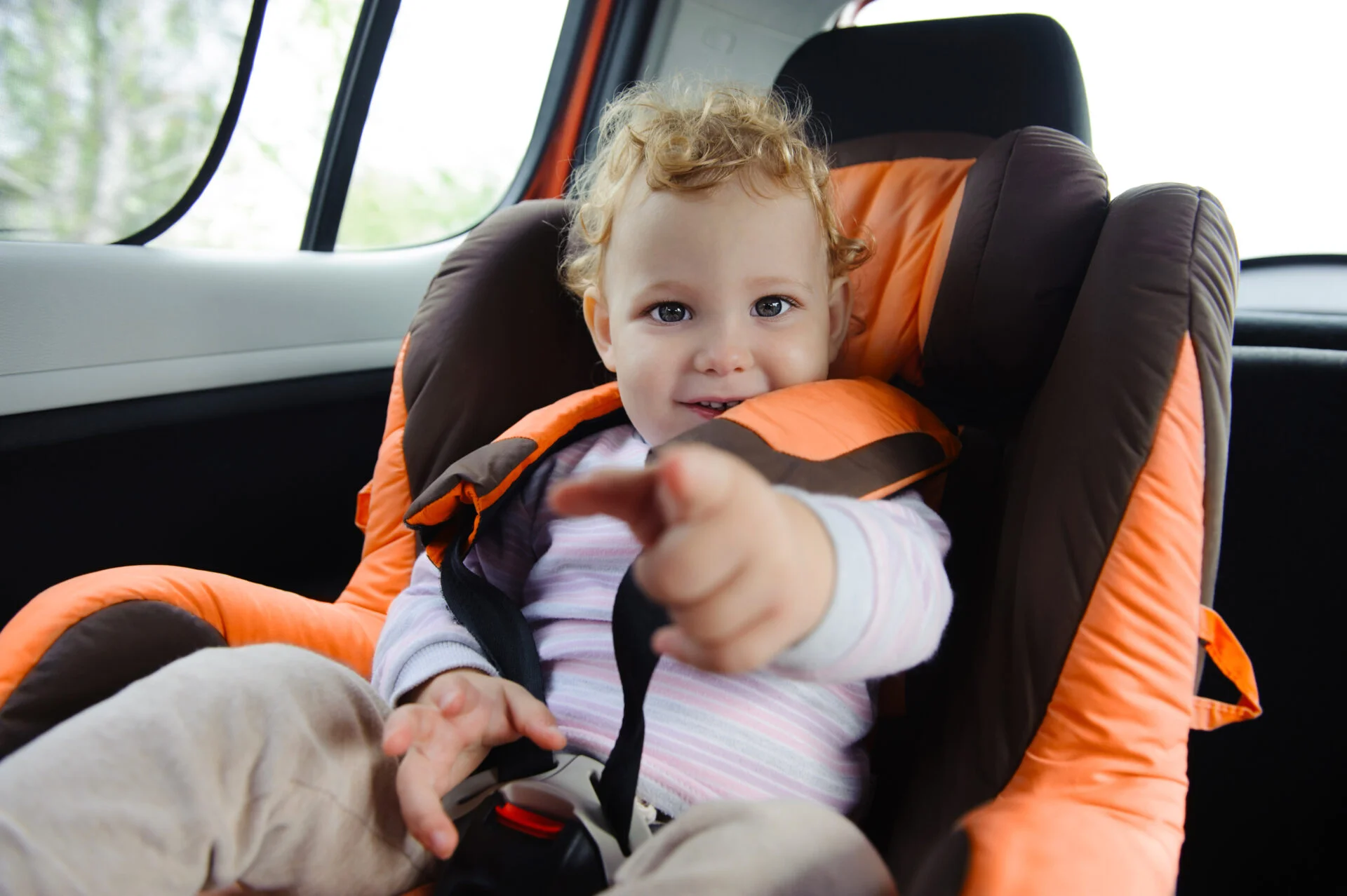 Cute baby enjoying a road trip in a baby car seat safe from fire retardants & PFAS 