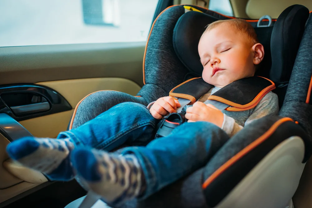 adorable baby asleep in his infant car seat