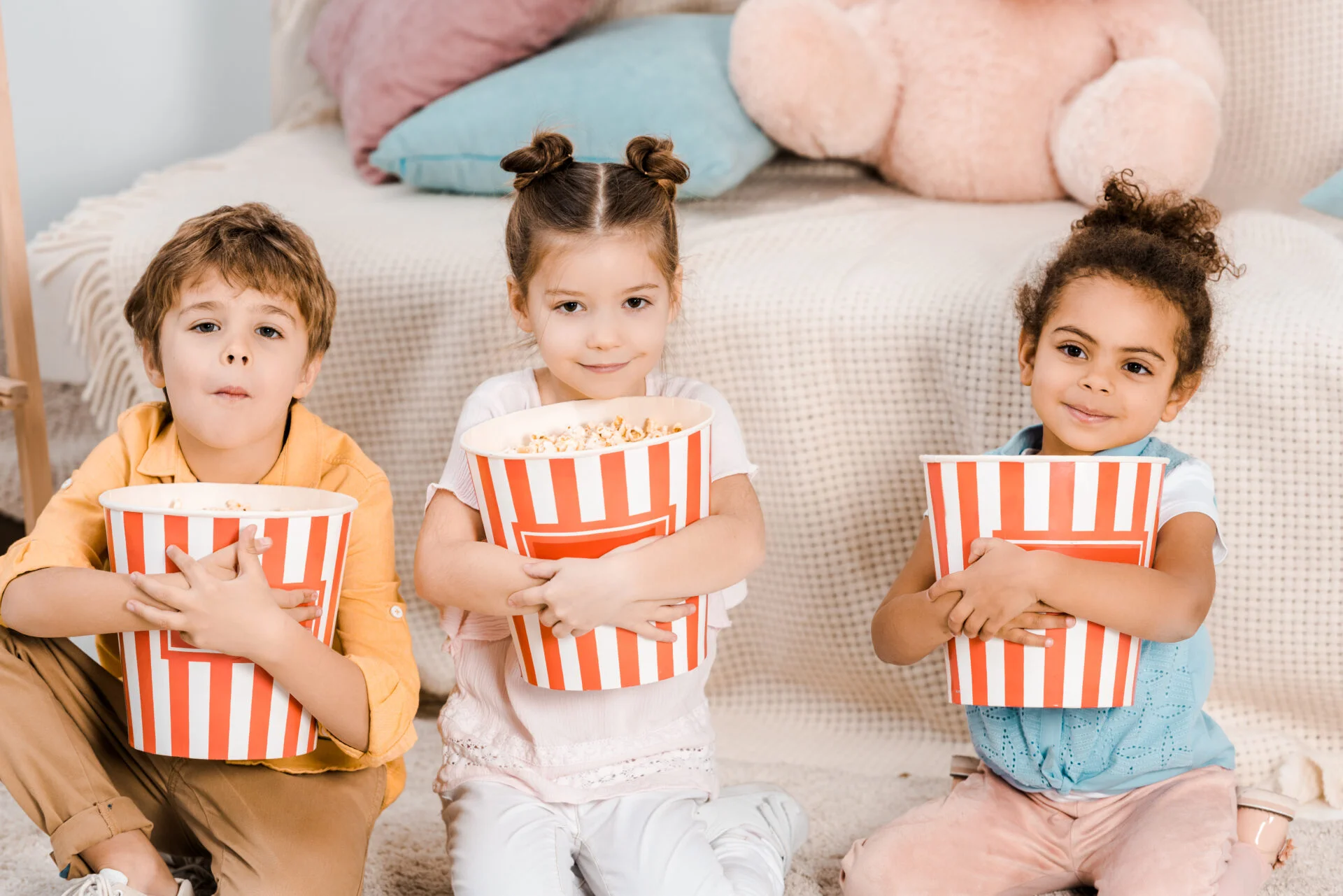 children eating popcorn in the home
