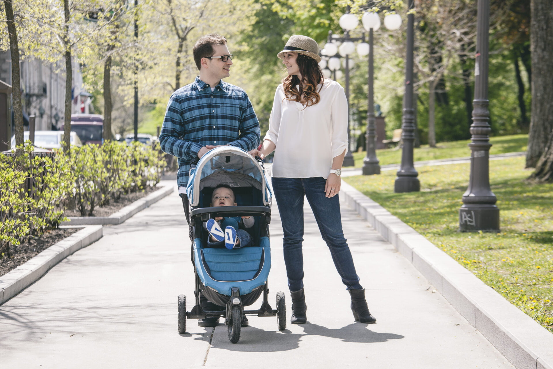 A young family with baby strollers on city walk