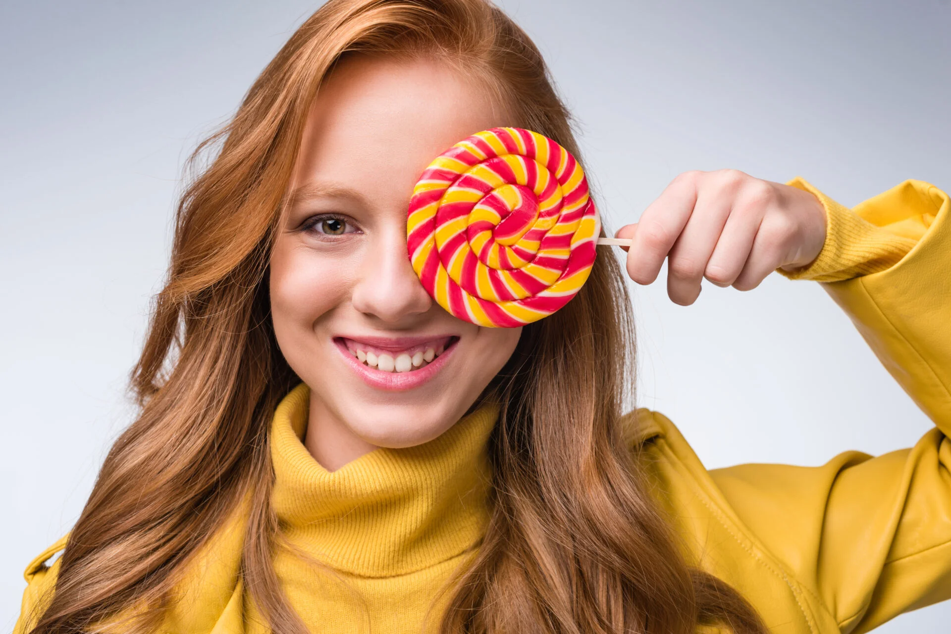 Redhead holding lollipop without titanium dioxide
