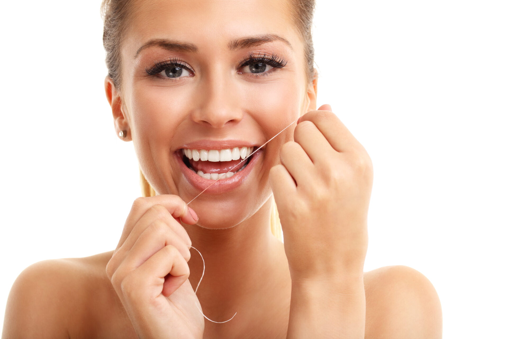 Picture of adult woman flossing her teeth 