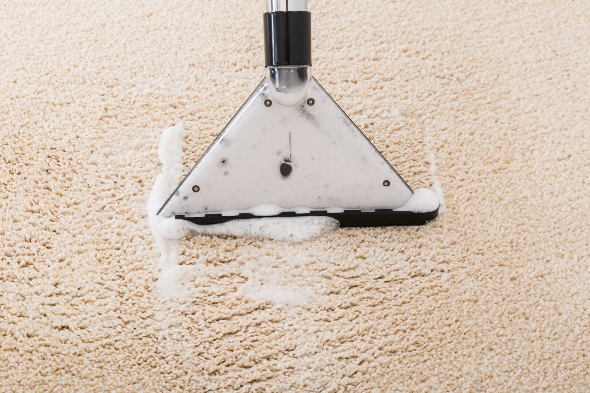 Close-up Of Vacuum Cleaner With Foam Over Wet Carpet