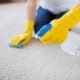 Woman cleaning carpet with a non-toxic carpet cleaner