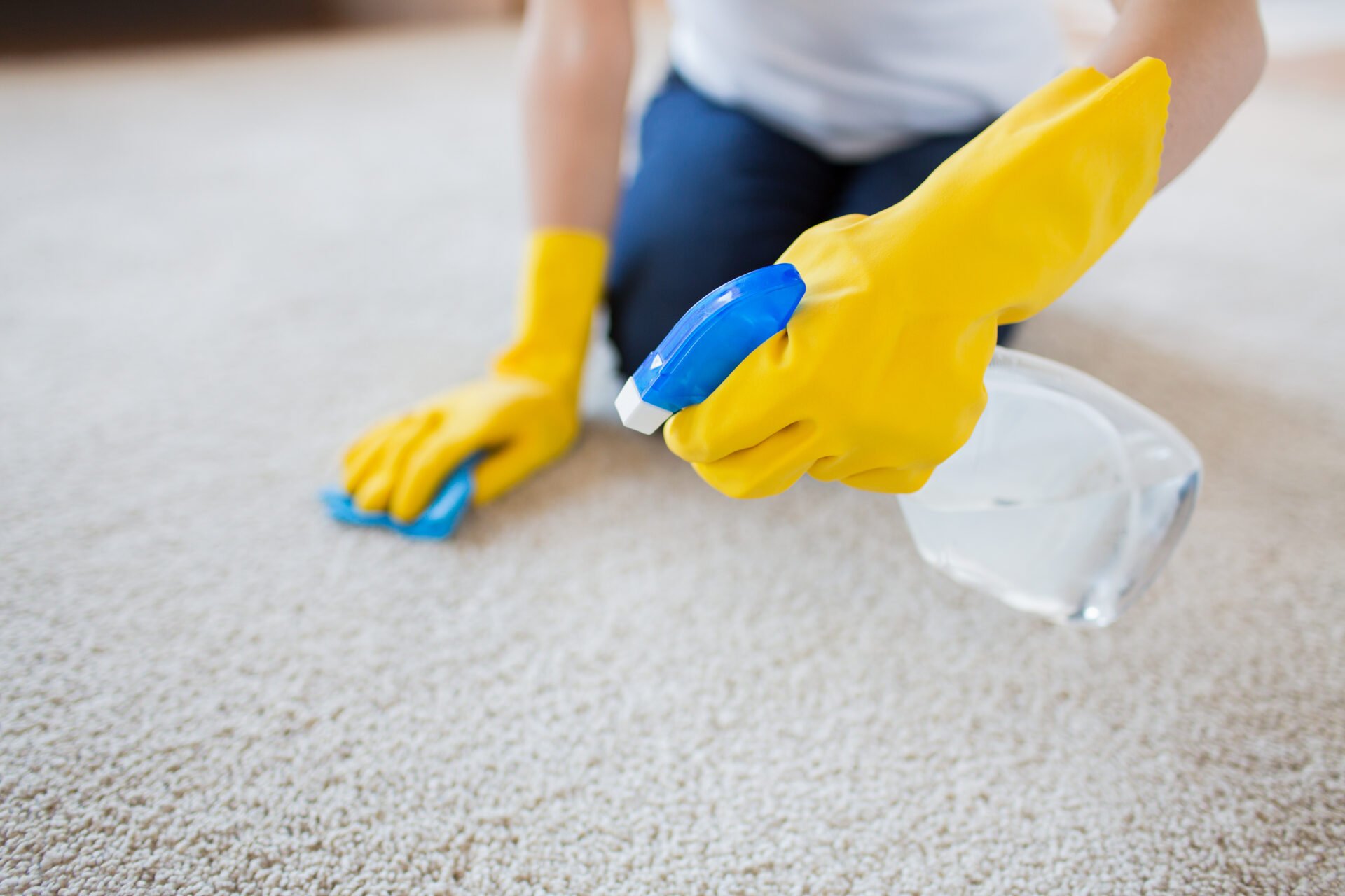 Woman cleaning carpet with a non-toxic carpet cleaner