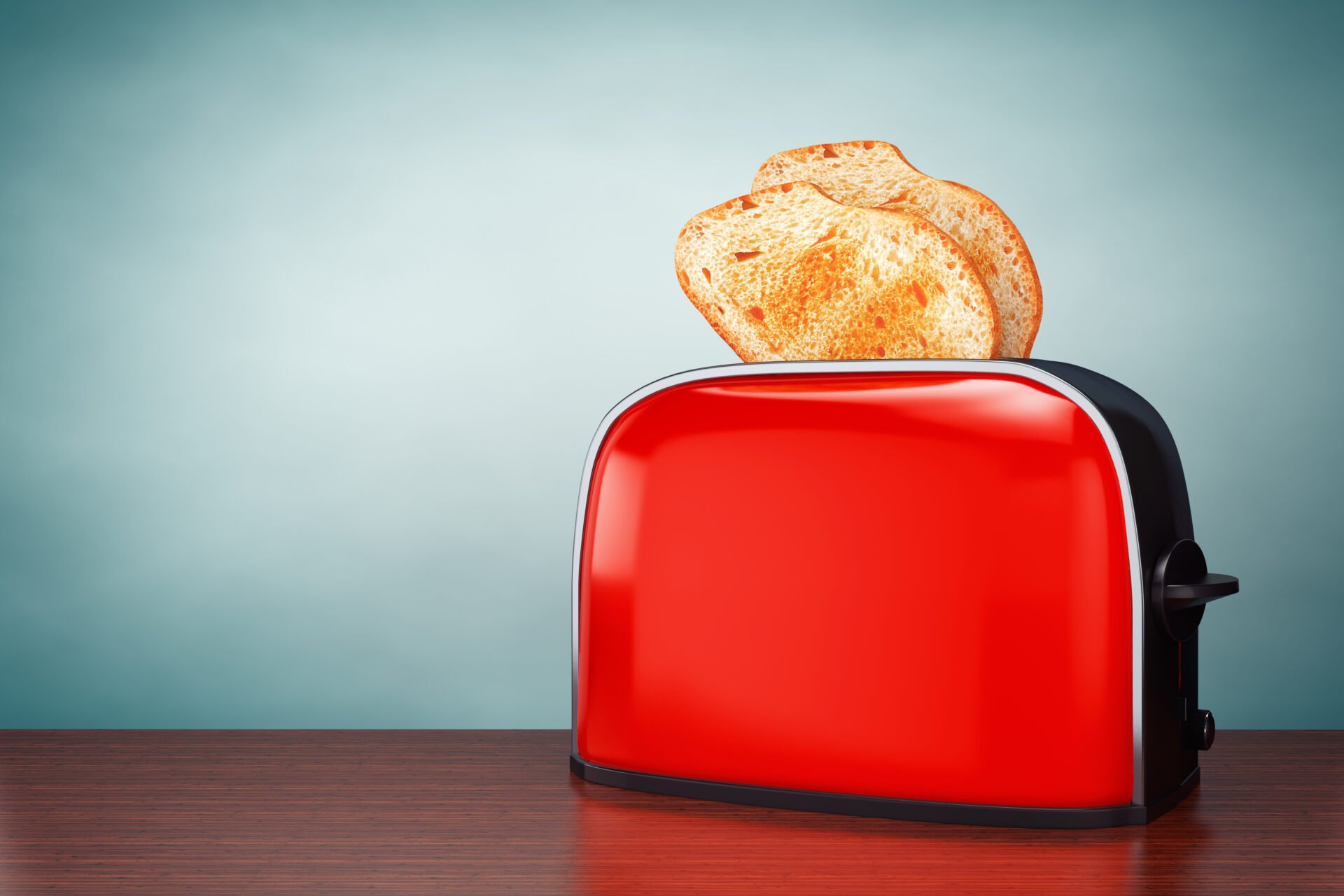 Red toaster oven with toast popping out