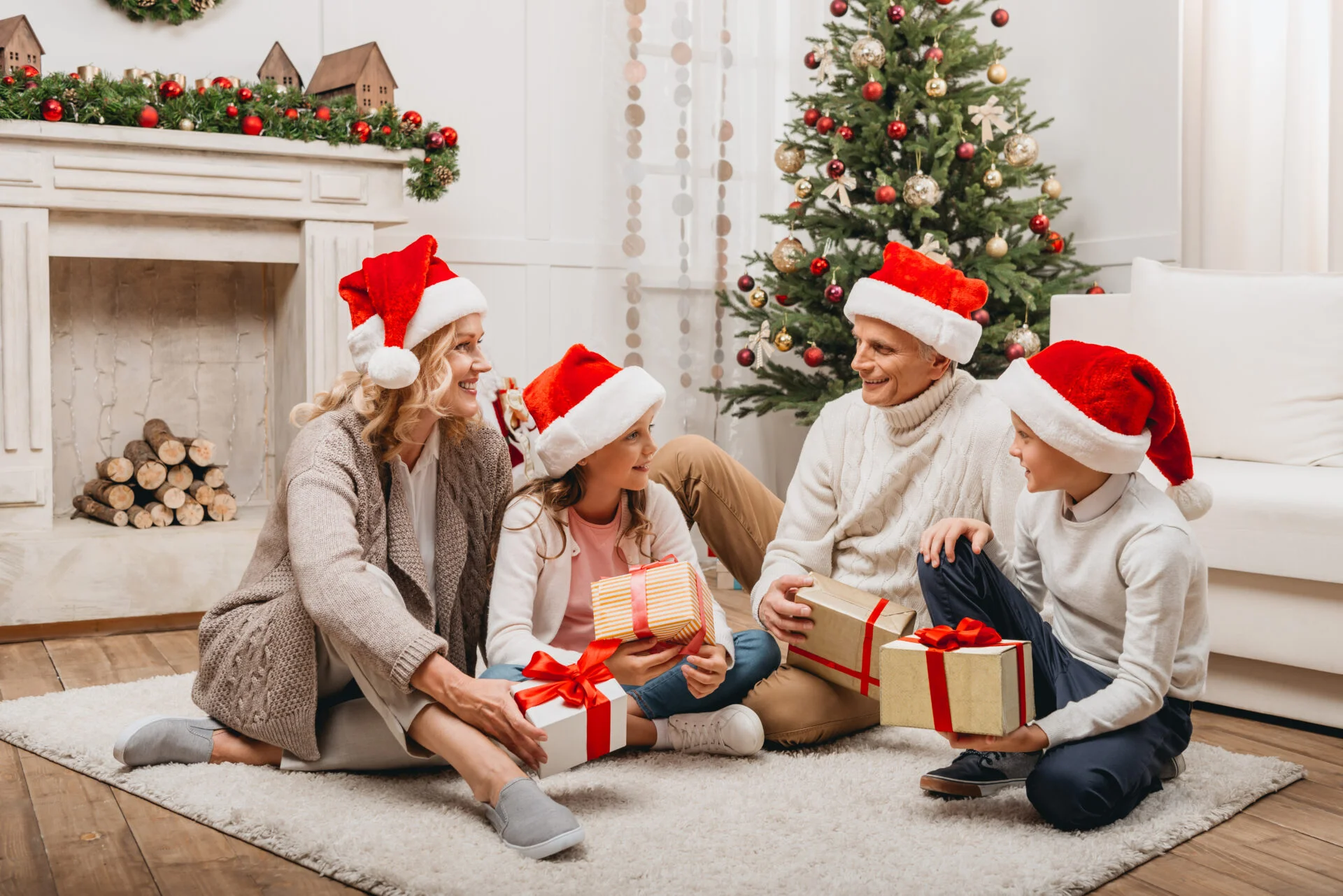 Family gathered around the Christmas tree opening up non-toxic holiday gifts