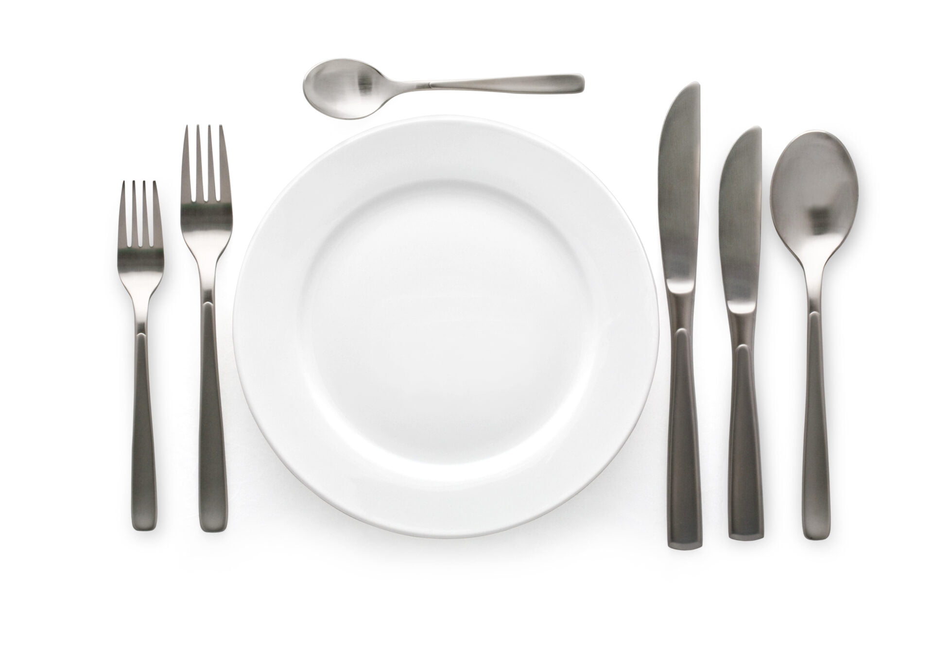 Place setting with plate, knife and fork. on white background