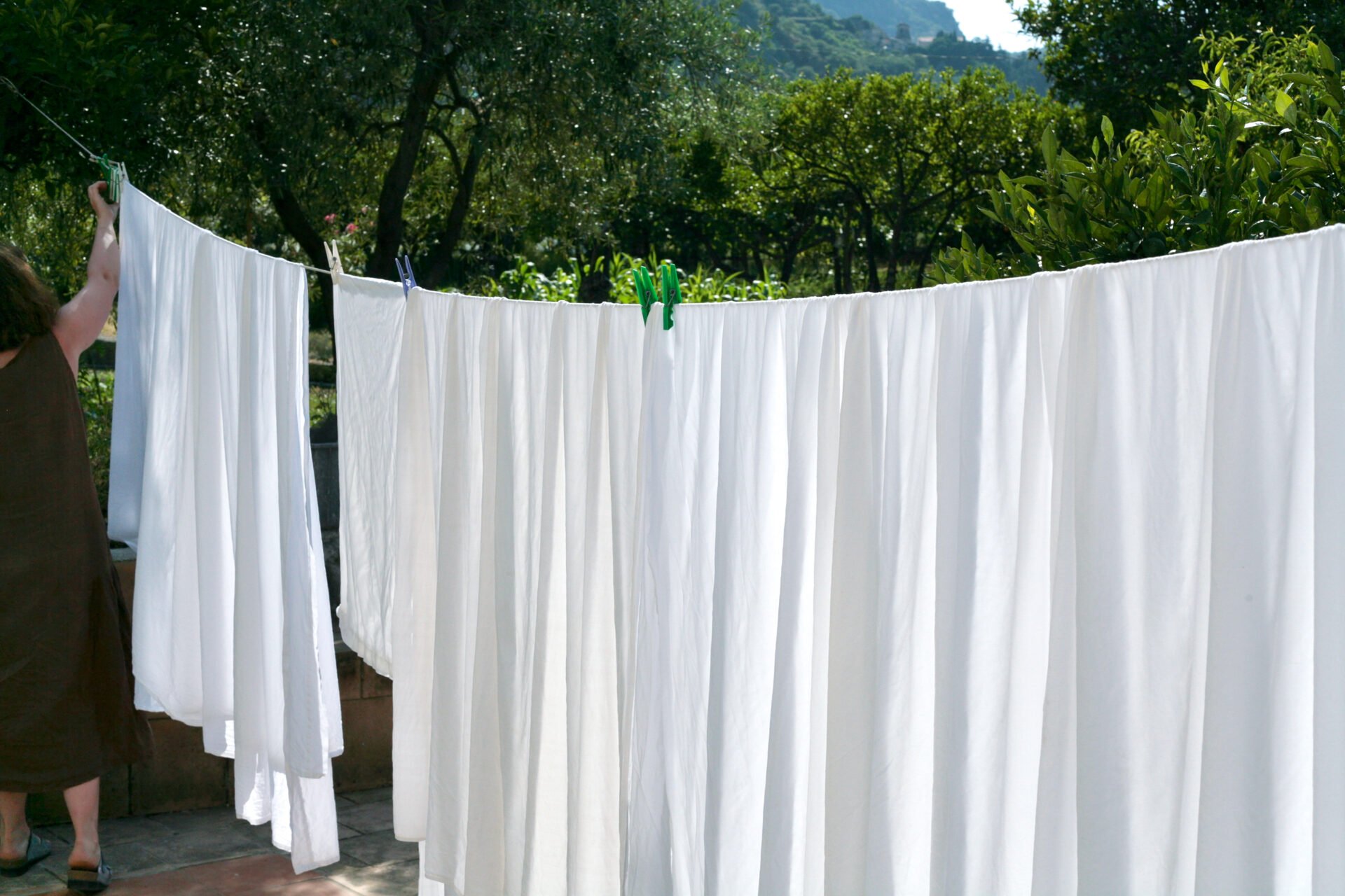 Organic cotton sheets being dried in the sun