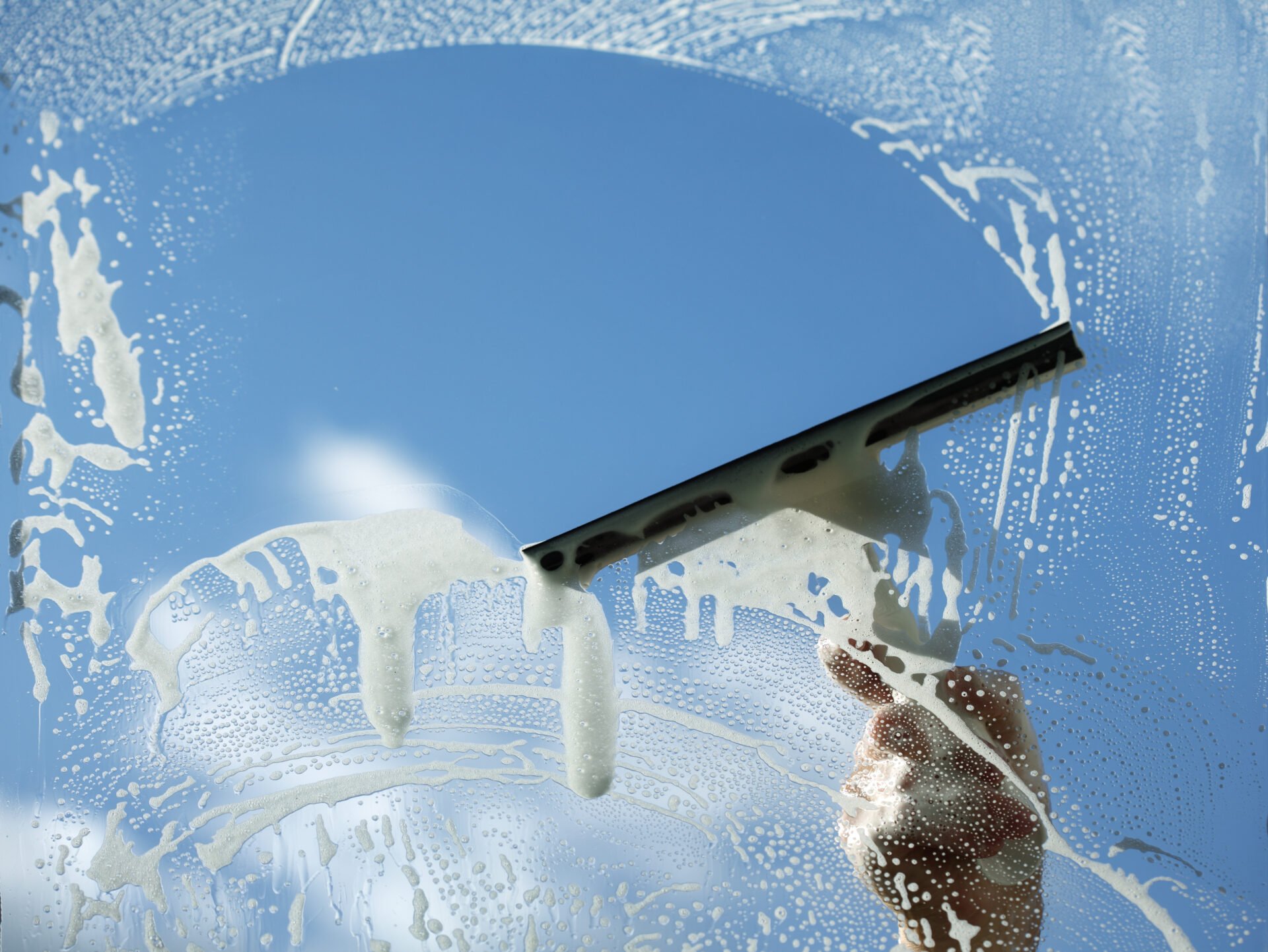 non-toxic Window cleaner using a squeegee to wash a window