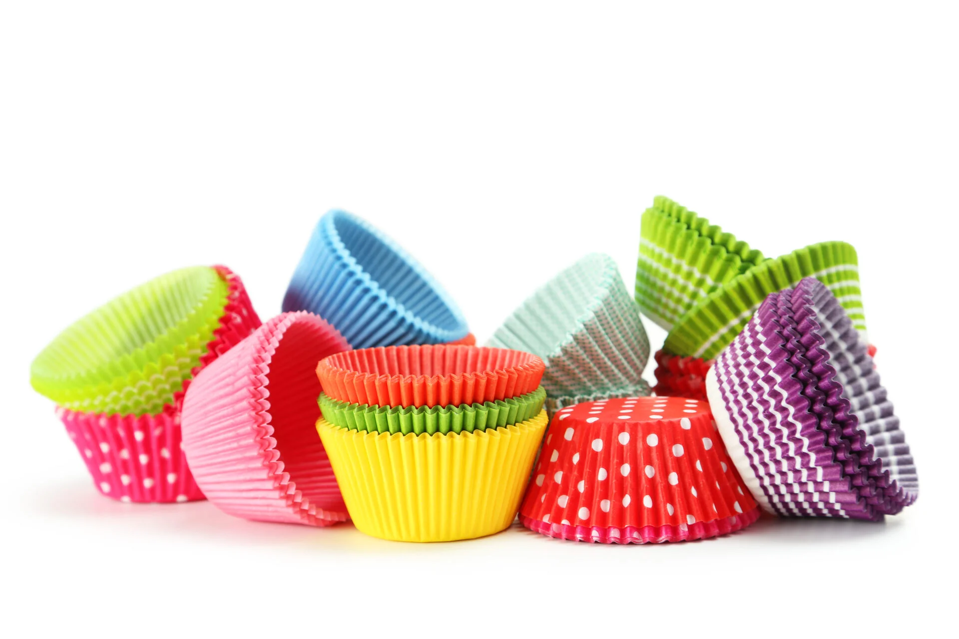 Empty colorful cupcake cases isolated on white