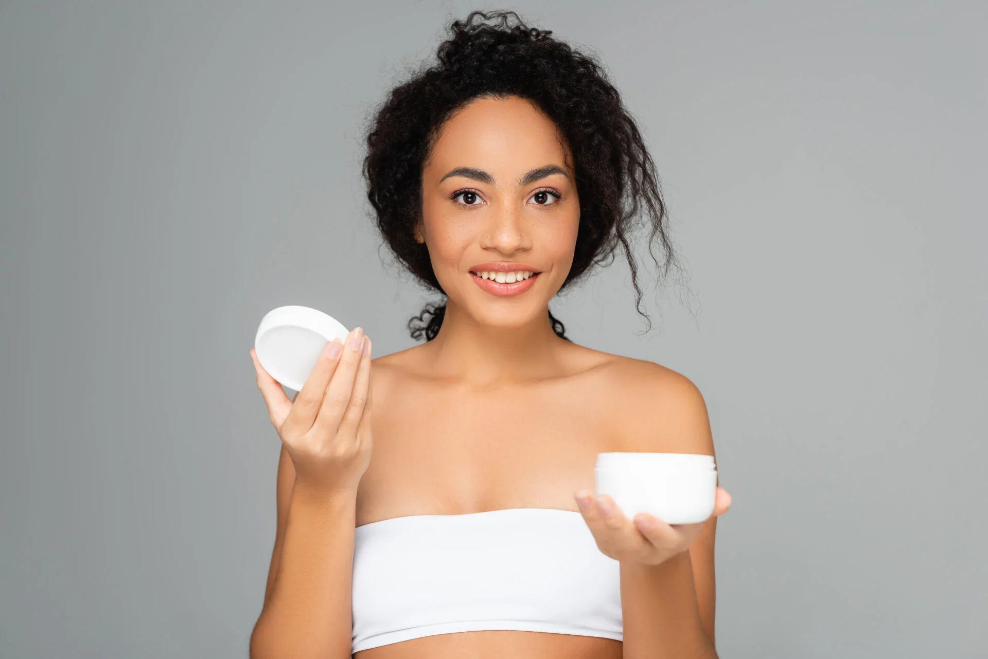 Woman holding non-toxic anti-aging cream