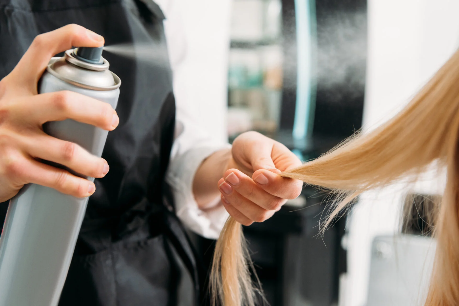 Woman getting hair sprayed with non-toxic & natural hair spray