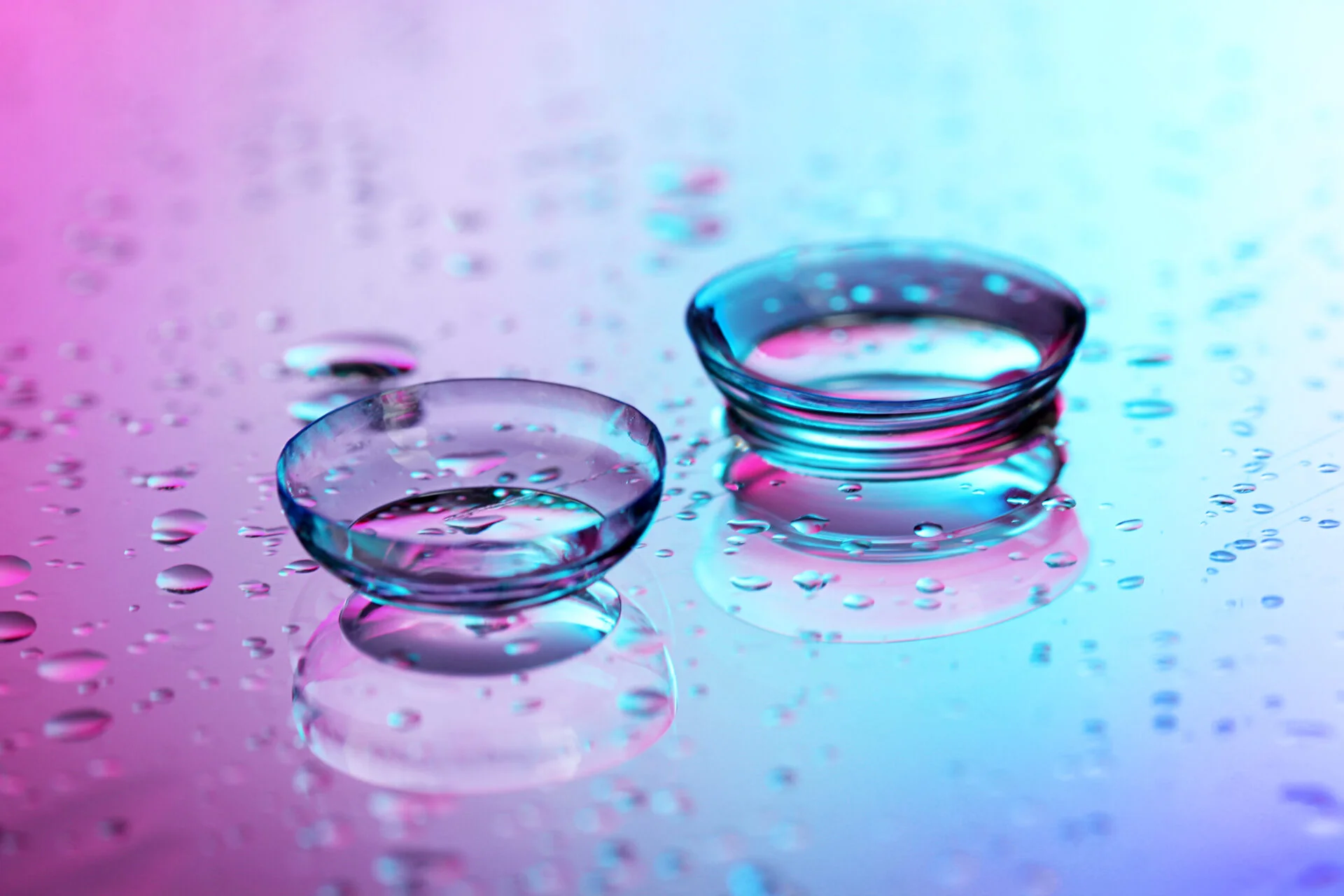 contact lenses with PFAS, on pink-blue background