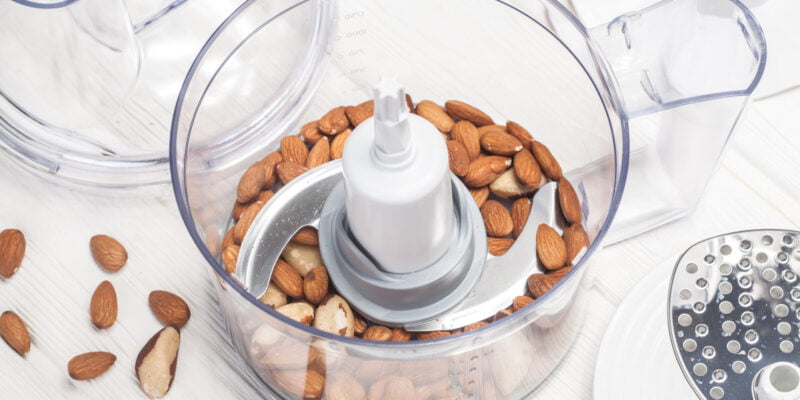 almonds in a food processor ready to be crushed for prepare dessert