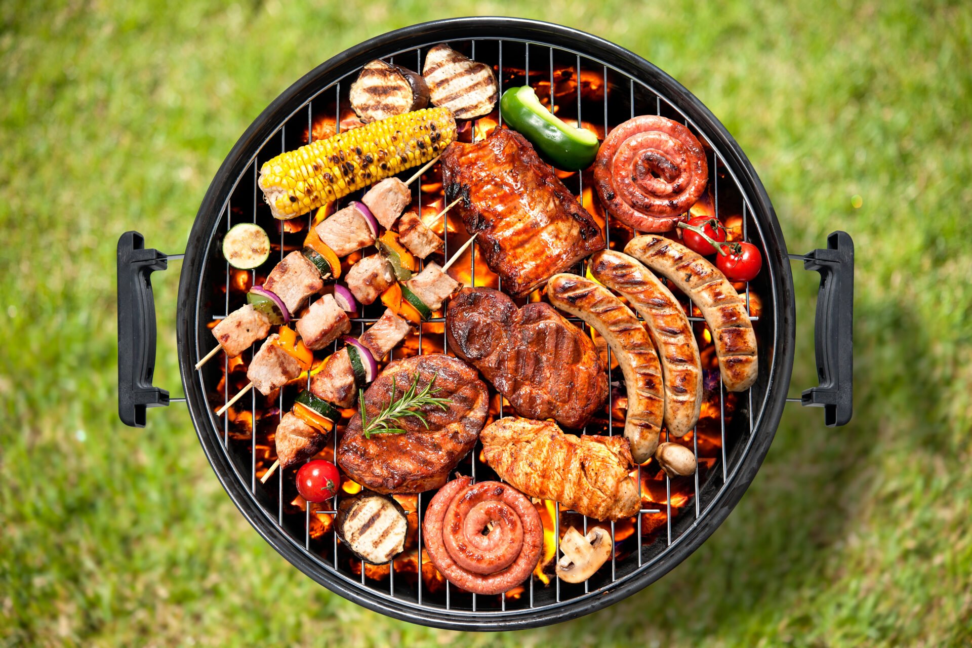 Assorted grilled meat with vegetable over the coals on a barbecue