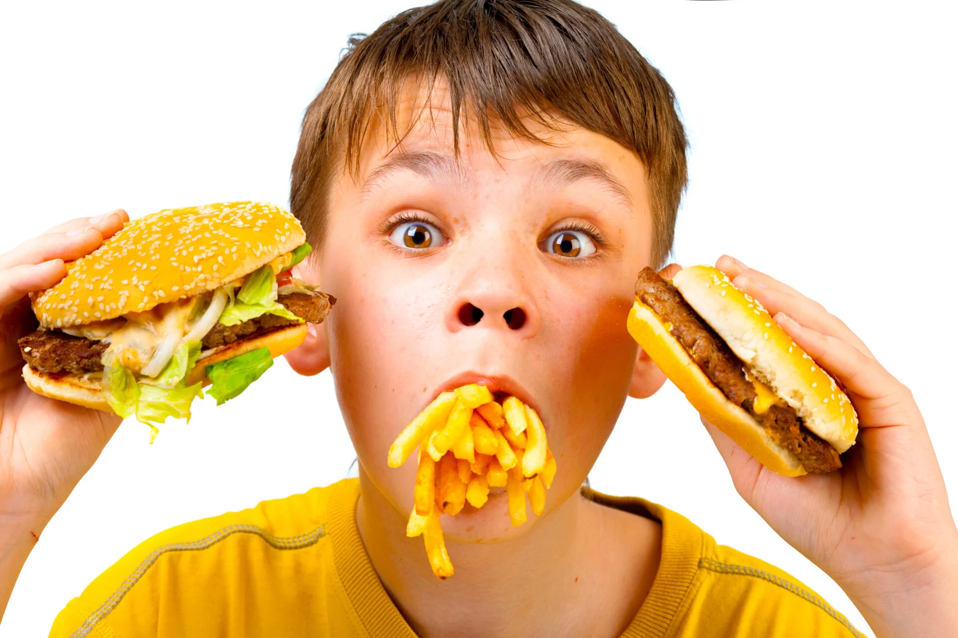 Boy with fast food meal in his mouth