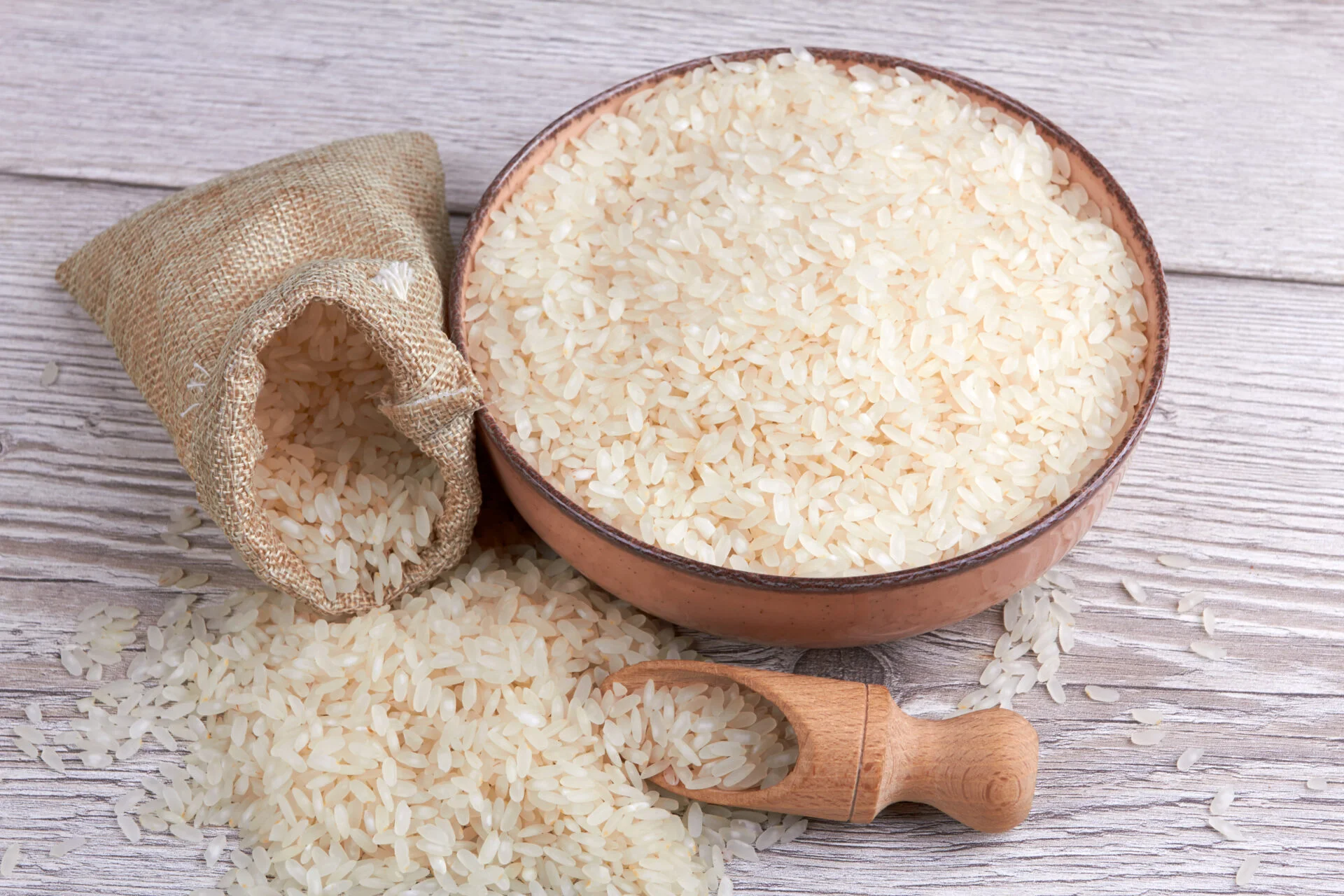 Rice in bowl on a wooden background