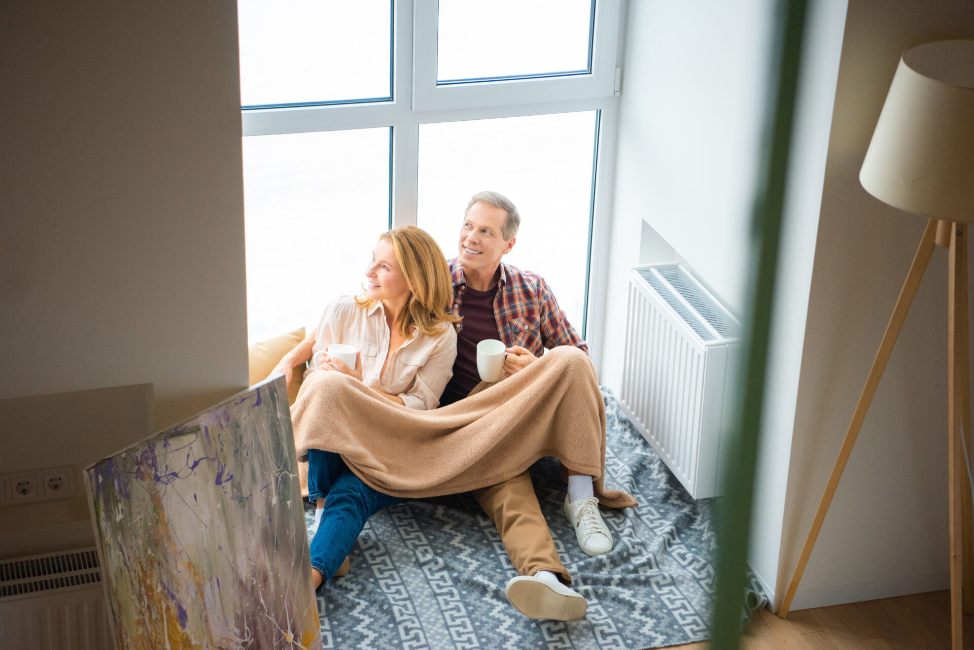 Man and wife in front of their window with a non-toxic weighted blanket