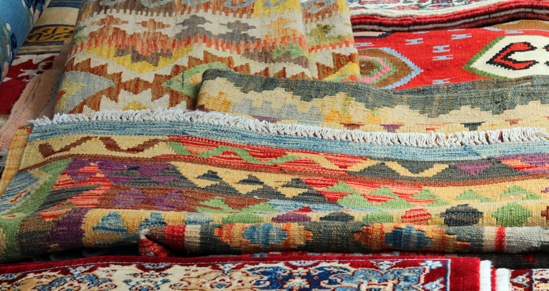 background of many carpets and kilim rugs for sale