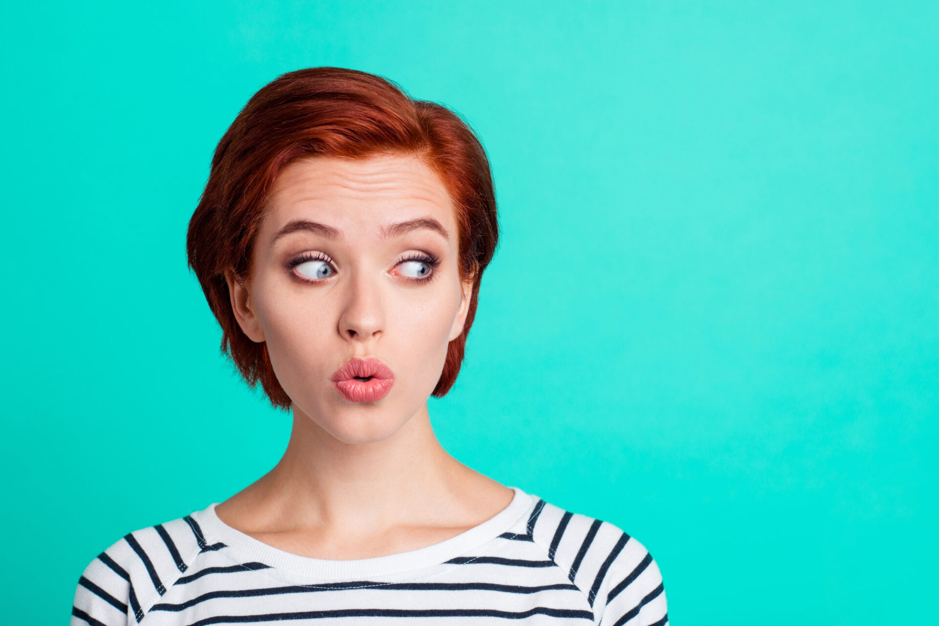 Close-up portrait of nice funny charming attractive lovely sweet red-haired lady in striped pullover air blow pouted lips looking aside isolated over bright vivid shine green turquoise background