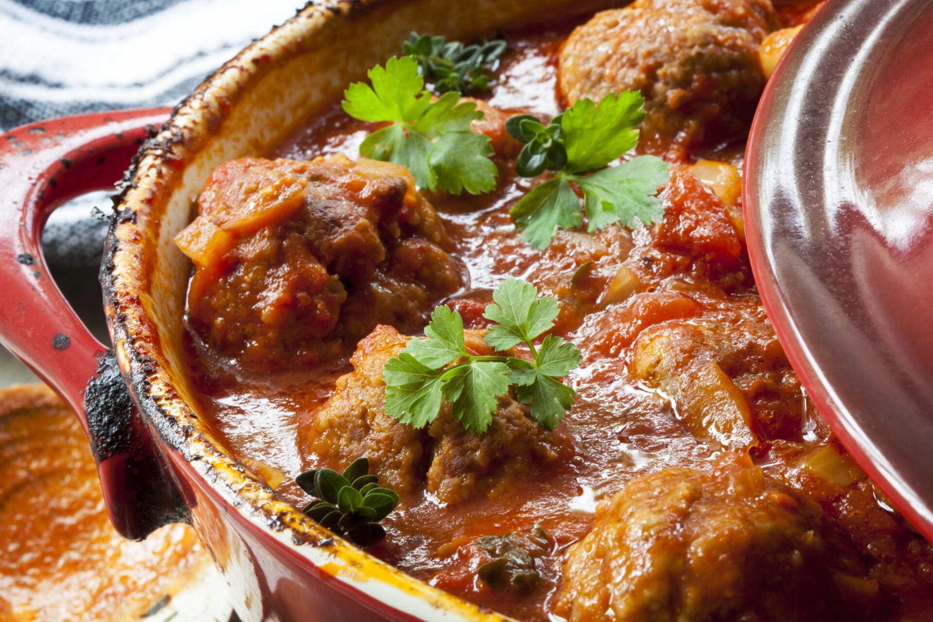 Slow cooker with meatballs inside cooking