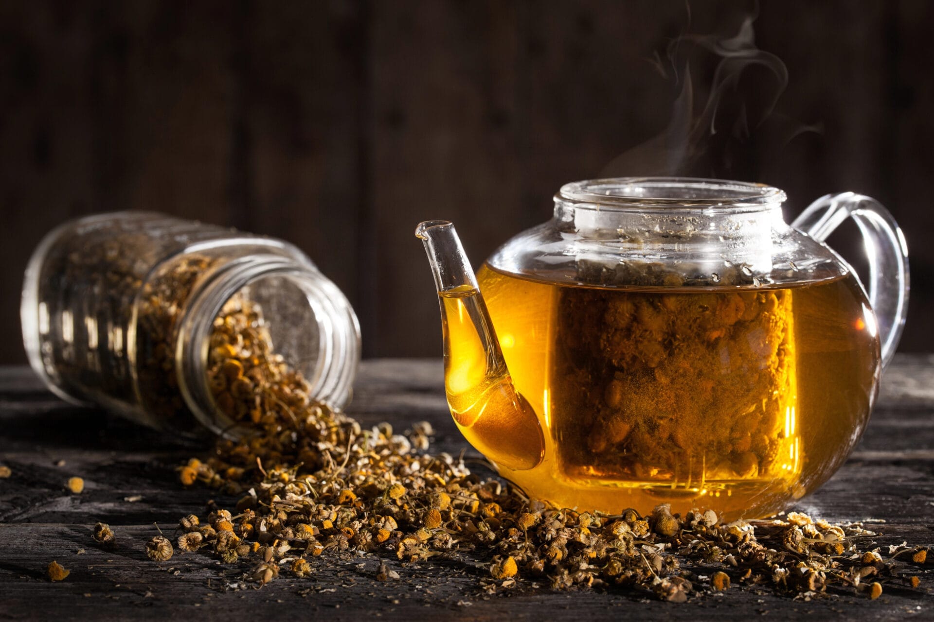 glass tea pot with chamomoile tea inside