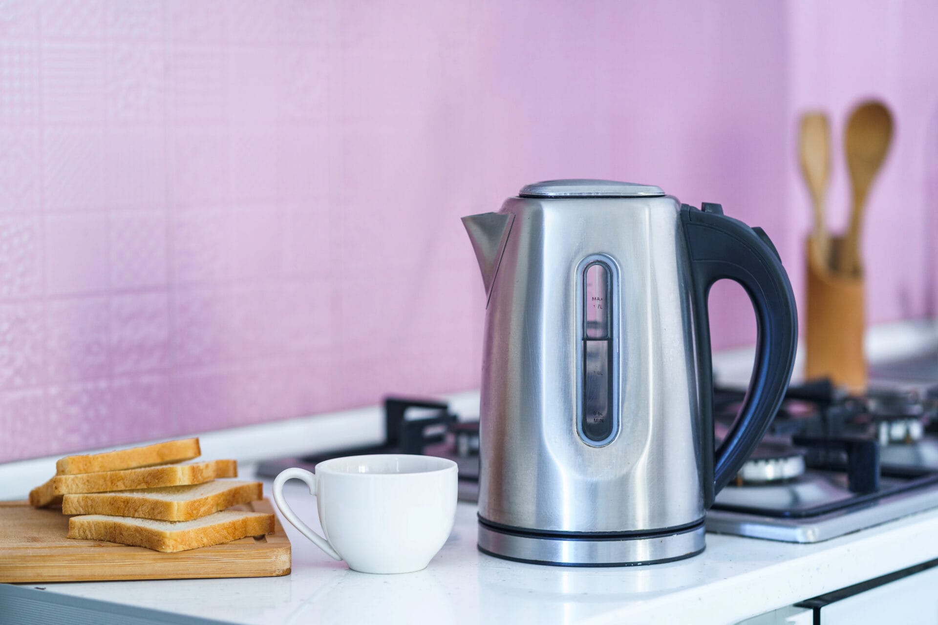 Electric tea kettle sitting on the table with breakfast